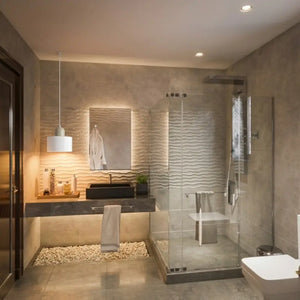 Lavabo moderno com revestimento em pedra cinza, decorado com um Pendente Nordic de vidro Branco suspenso sobre a cuba, criando uma iluminação de destaque elegante